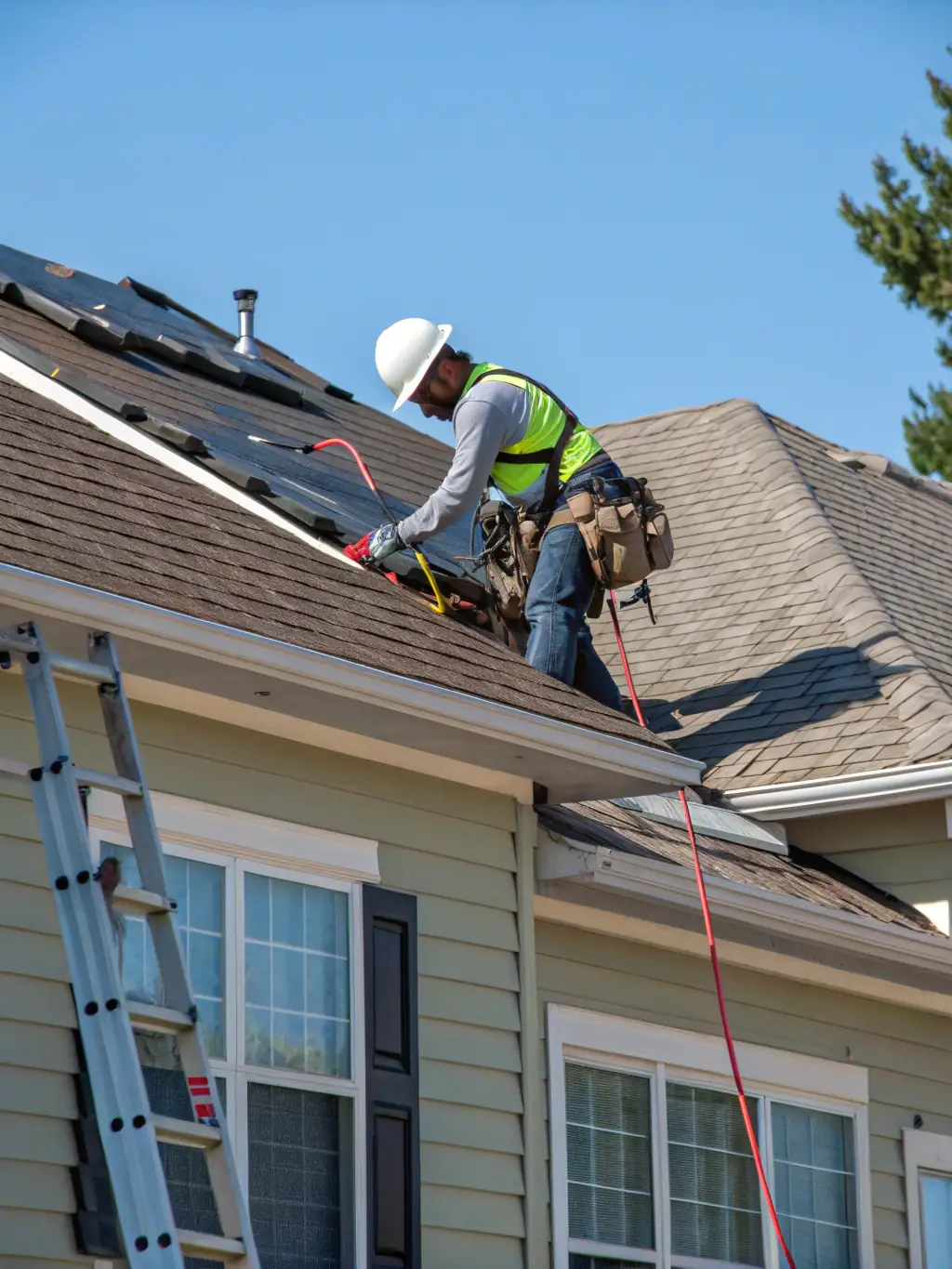 A team installing a new shingle roof on a residential home, ensuring proper alignment and secure attachment of the shingles.