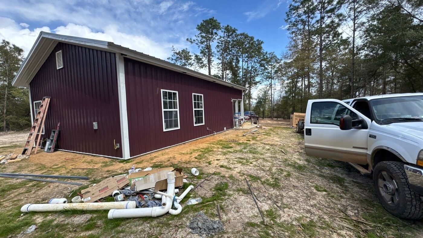 Custom barndominium exterior with metal roof and siding by JB's Contracting, NW Florida