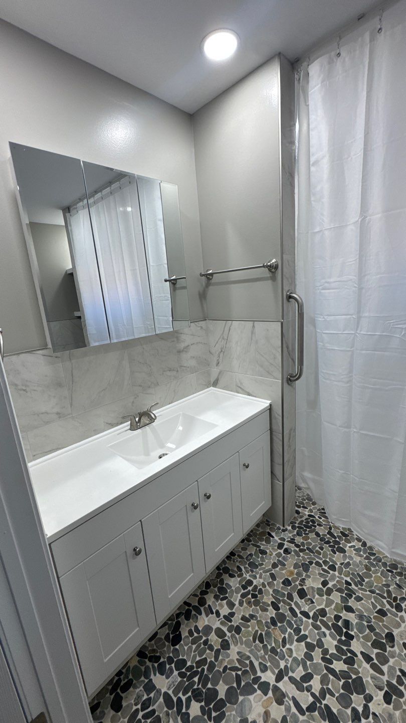 White vanity in a tiled bathroom