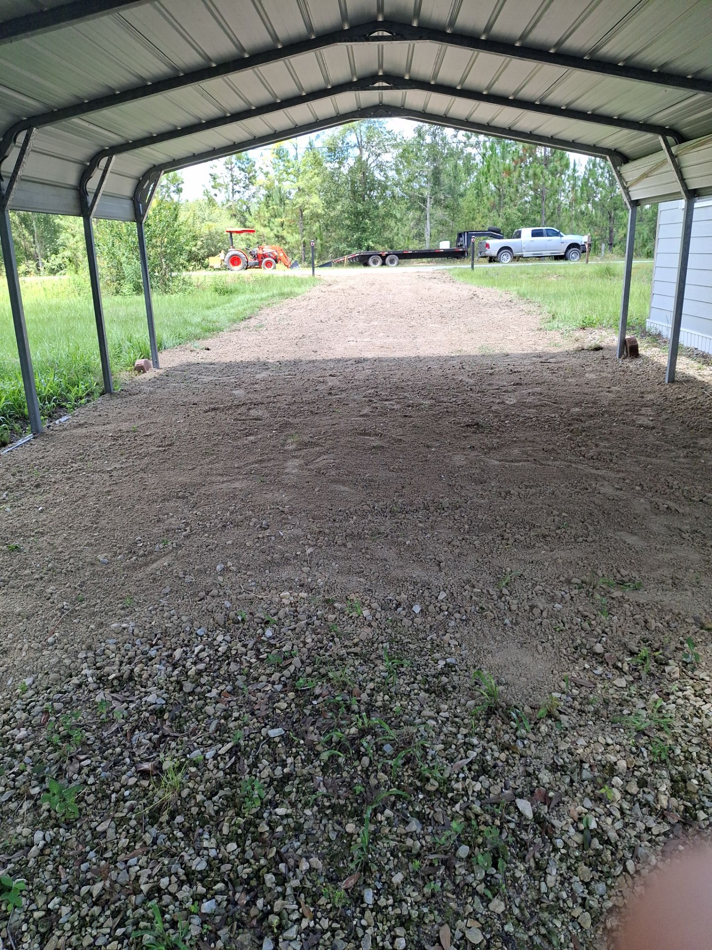 Graded ground beneath a metal carport