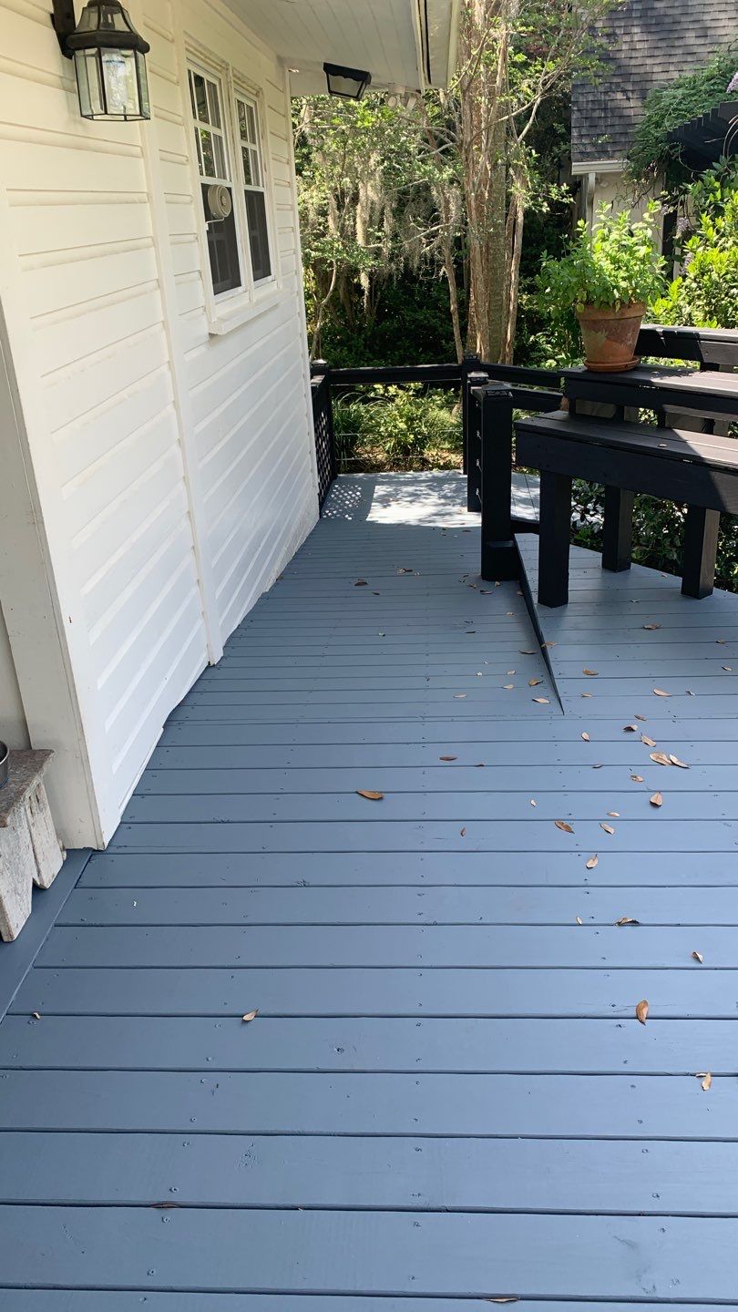 Painted custom deck walkway beside exterior siding