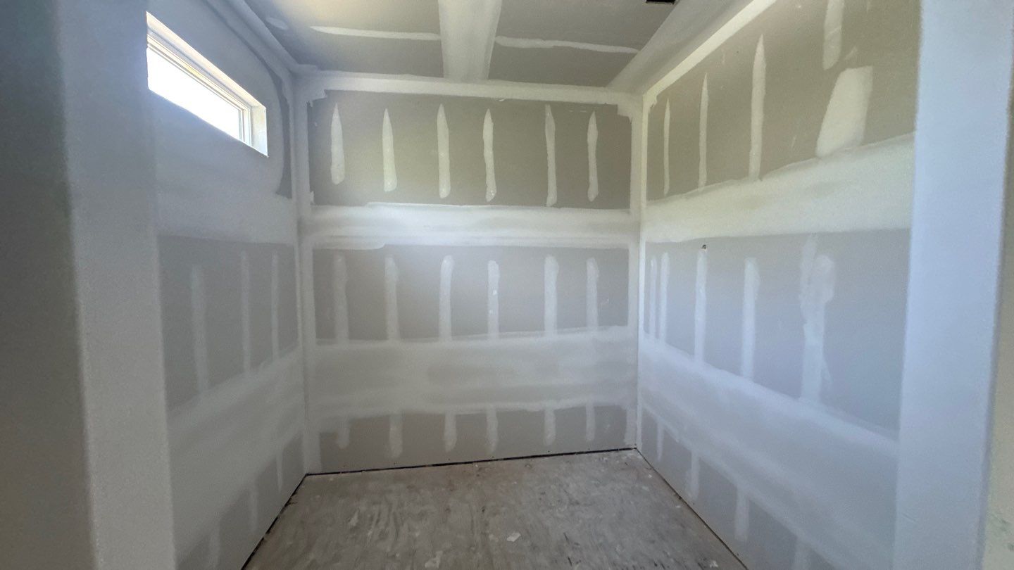 Taped drywall joints in a cleared room