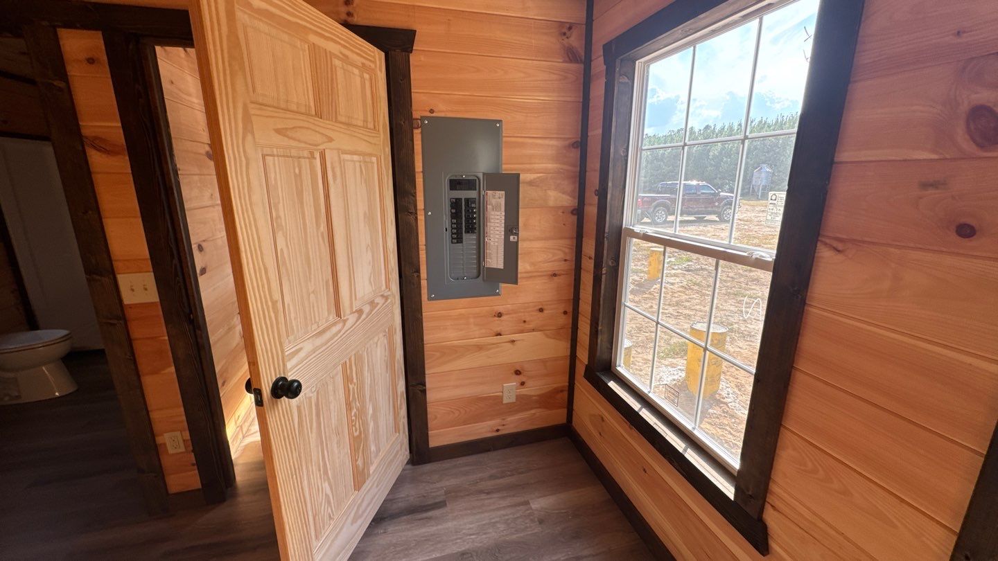 Electrical panel in a wood-lined room