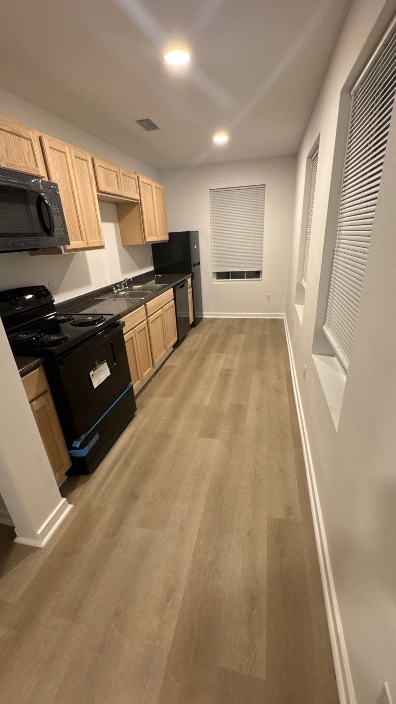 Galley kitchen with wood cabinets