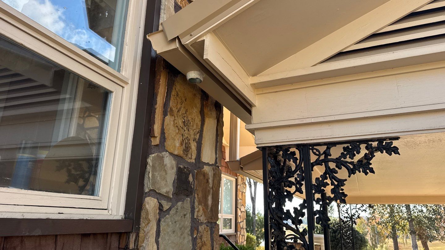 Gutter outlet beside a covered entry during installation