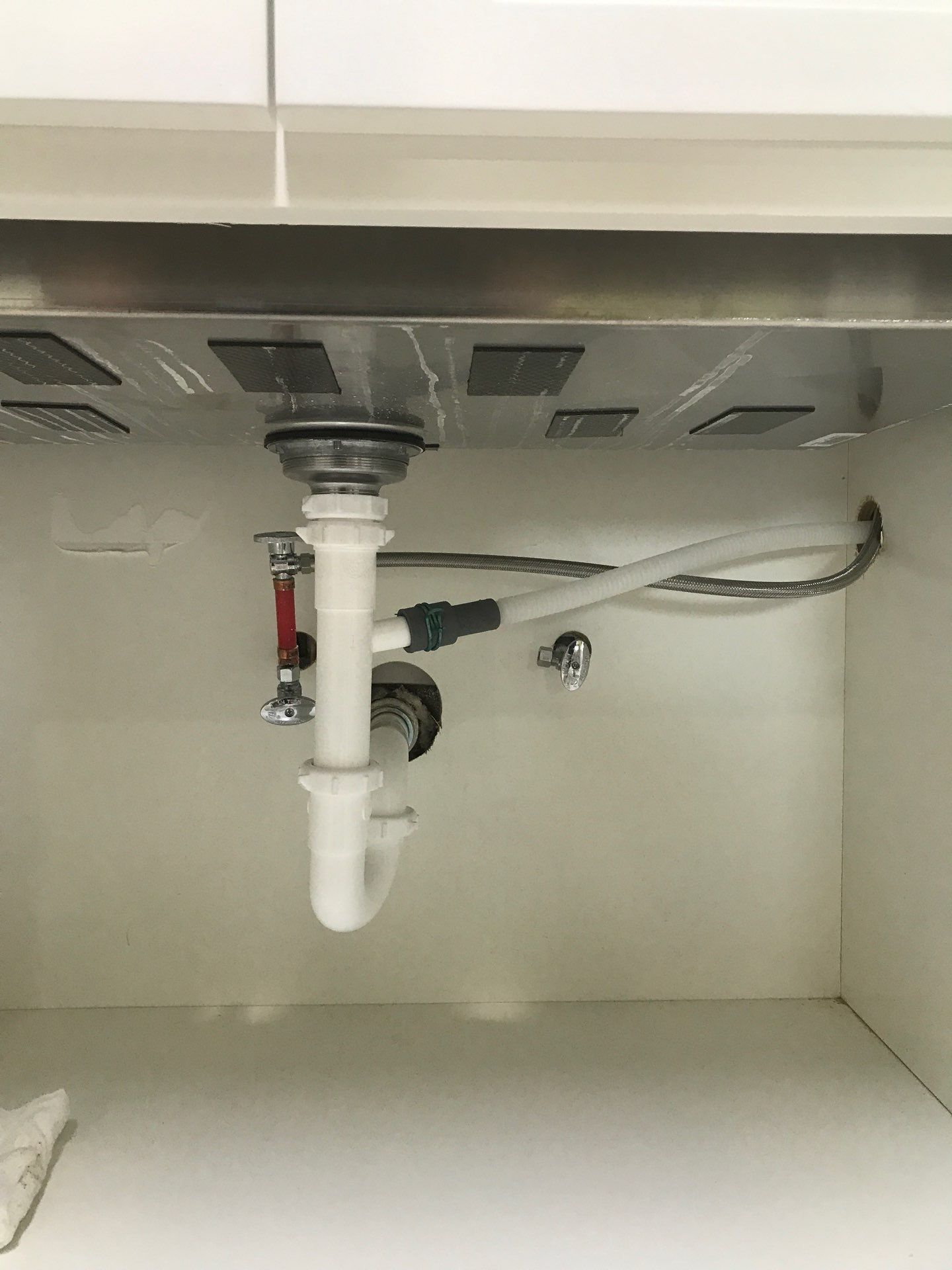 Replacement P-trap beneath a kitchen sink