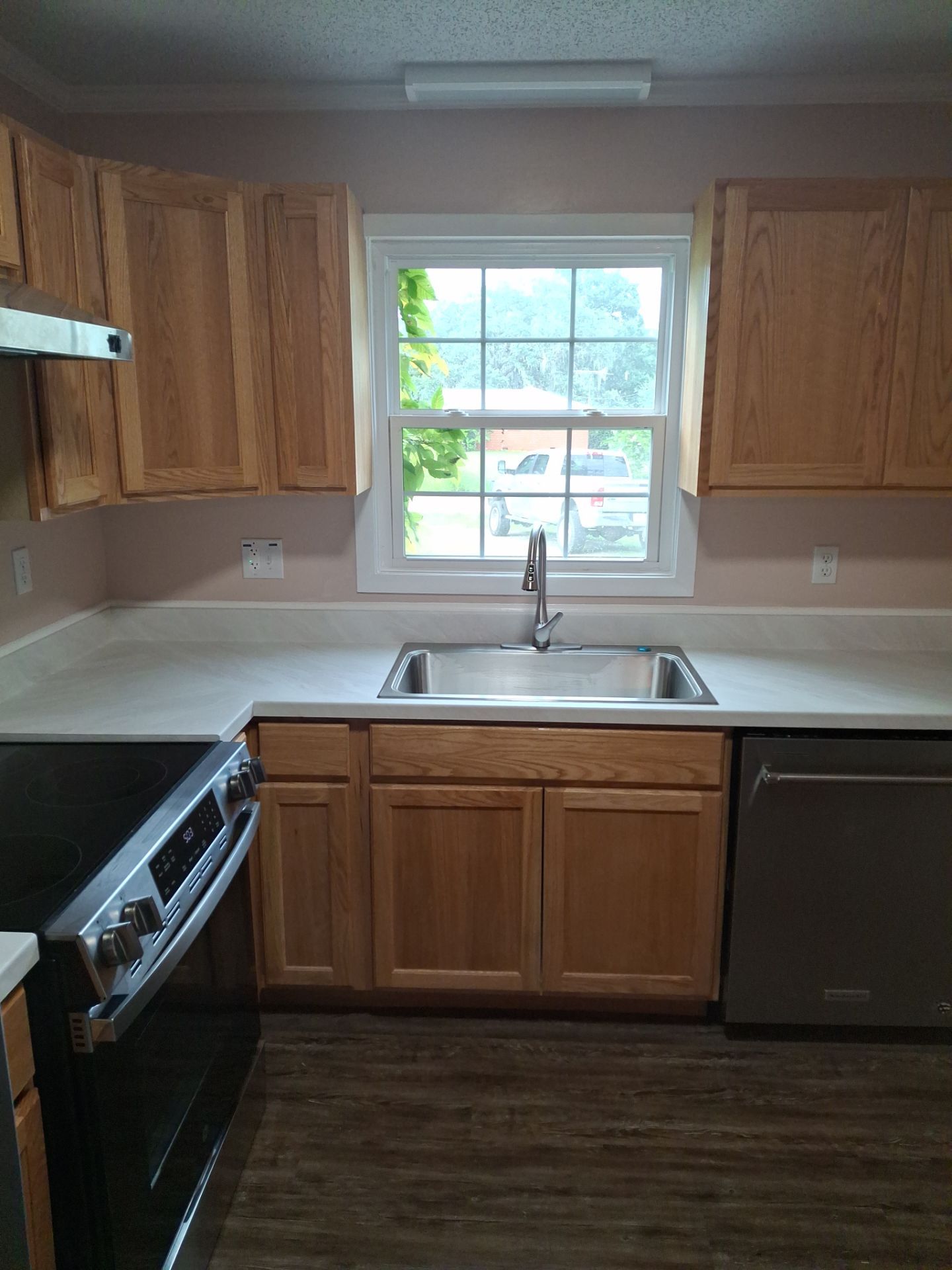 Kitchen sink and surrounding wood cabinets