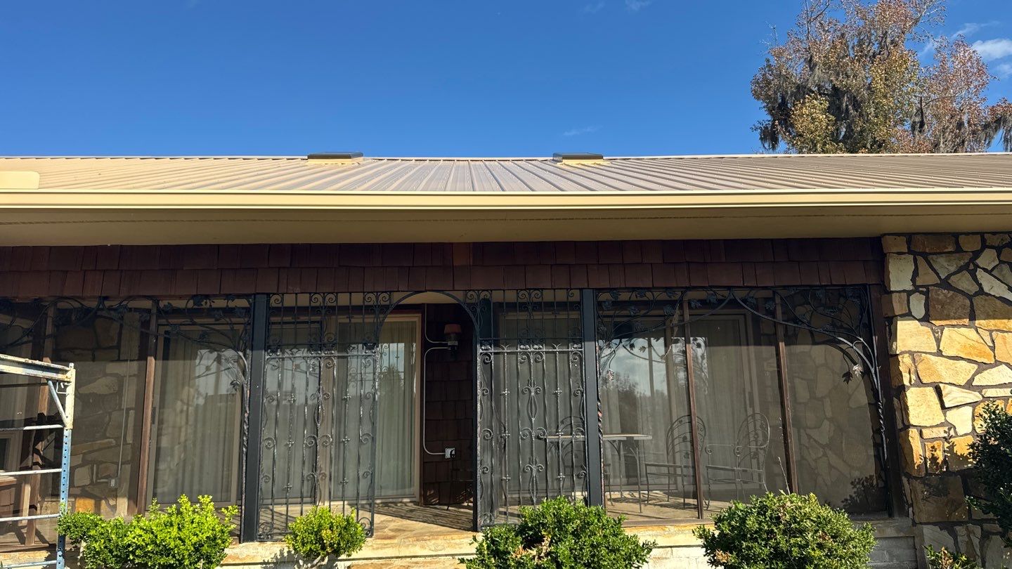 Matching gutter beneath a metal roof