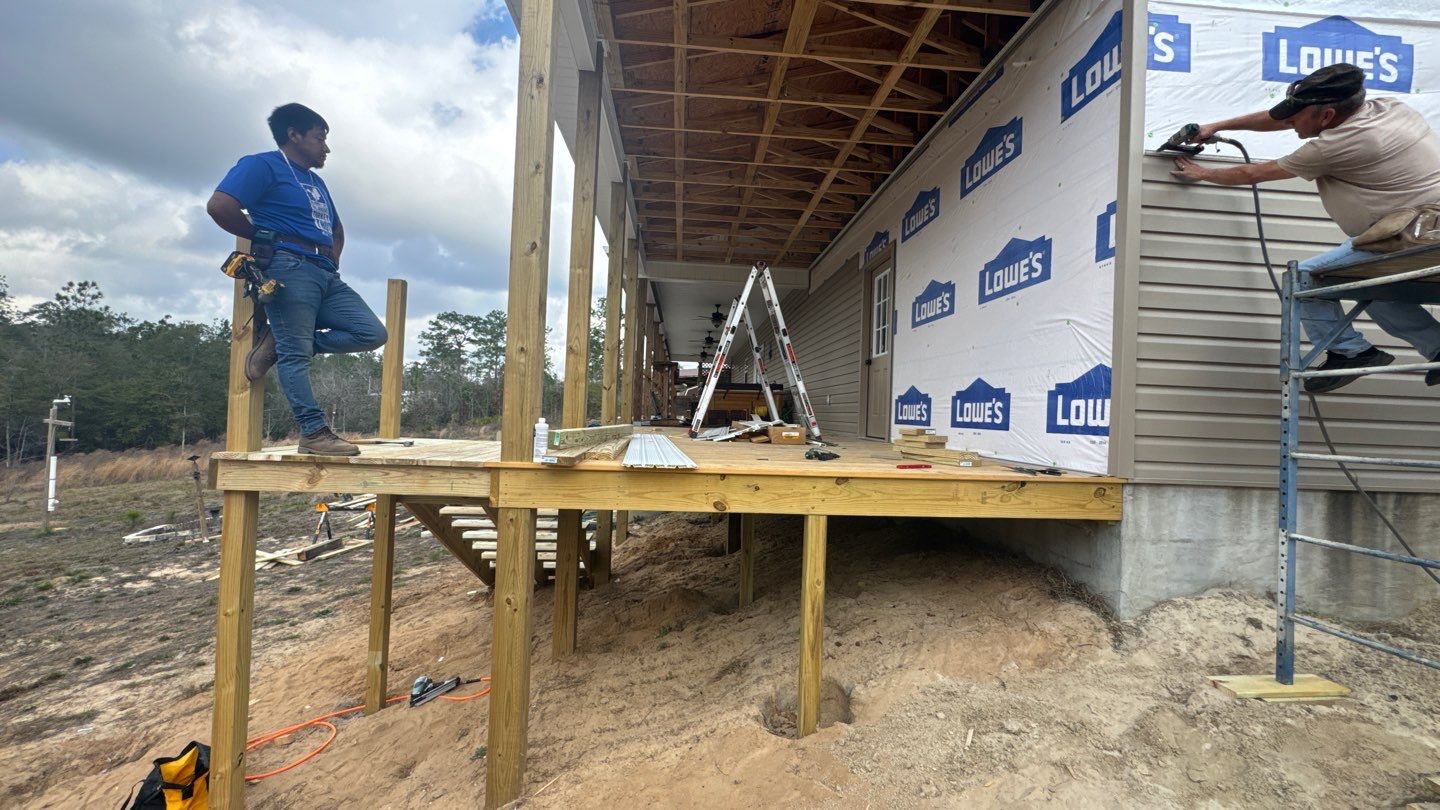 Crew installing siding beside a porch