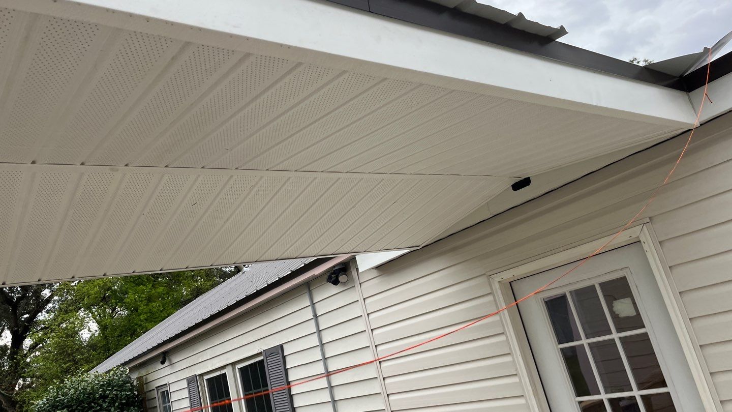 White soffit panels beneath a roof connection