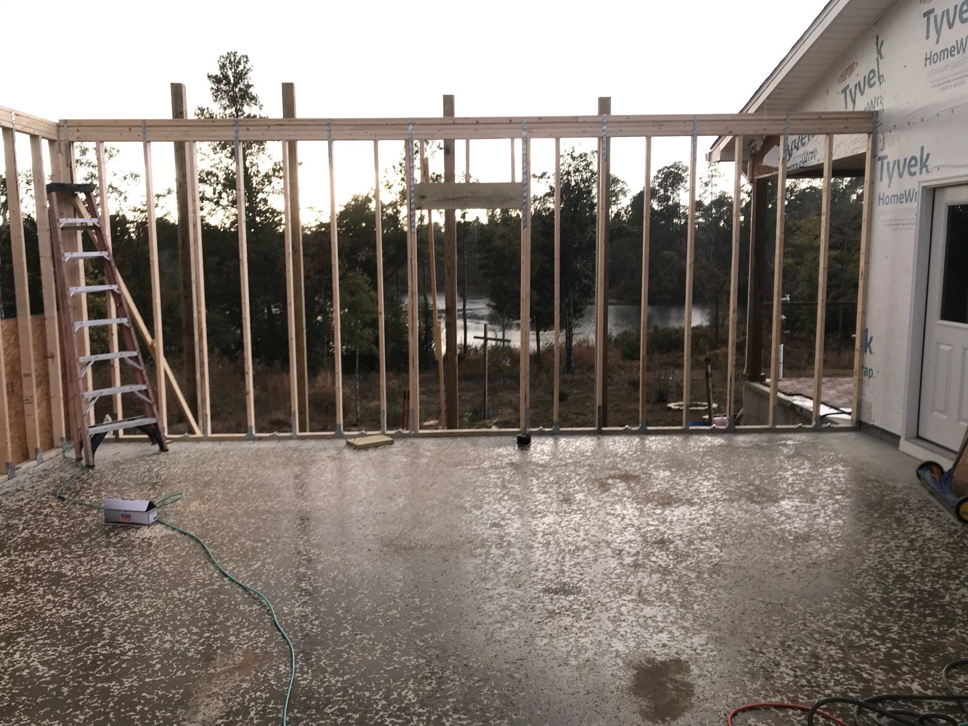 Framed wall and opening beside an existing structure
