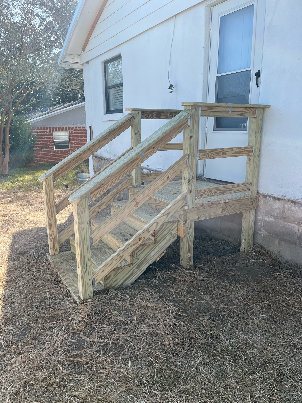 Wood entry steps with landing and handrails