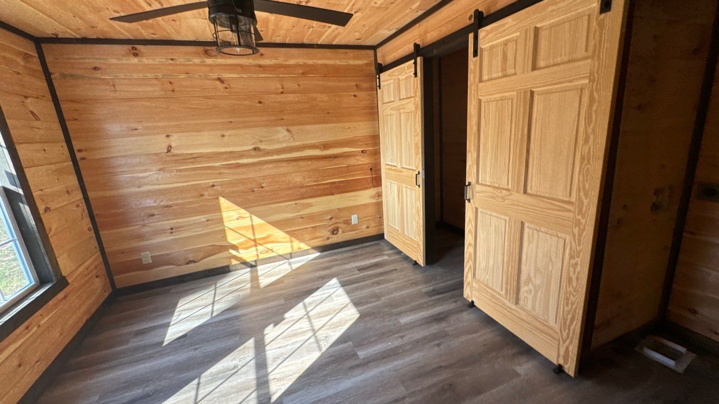 Wood-lined room with sliding-door storage